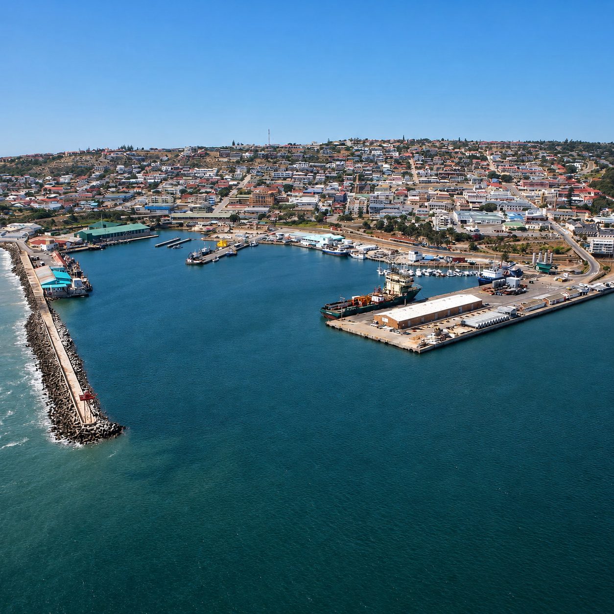 Aerial view of the Port of Mossel Bay, South Africa: breakwater, harbour basin and quay; Afrishore's founding base and head office, where it operated the Block 11B/12B (Brulpadda/Luiperd) offshore supply base and runs its vessel & rig agency