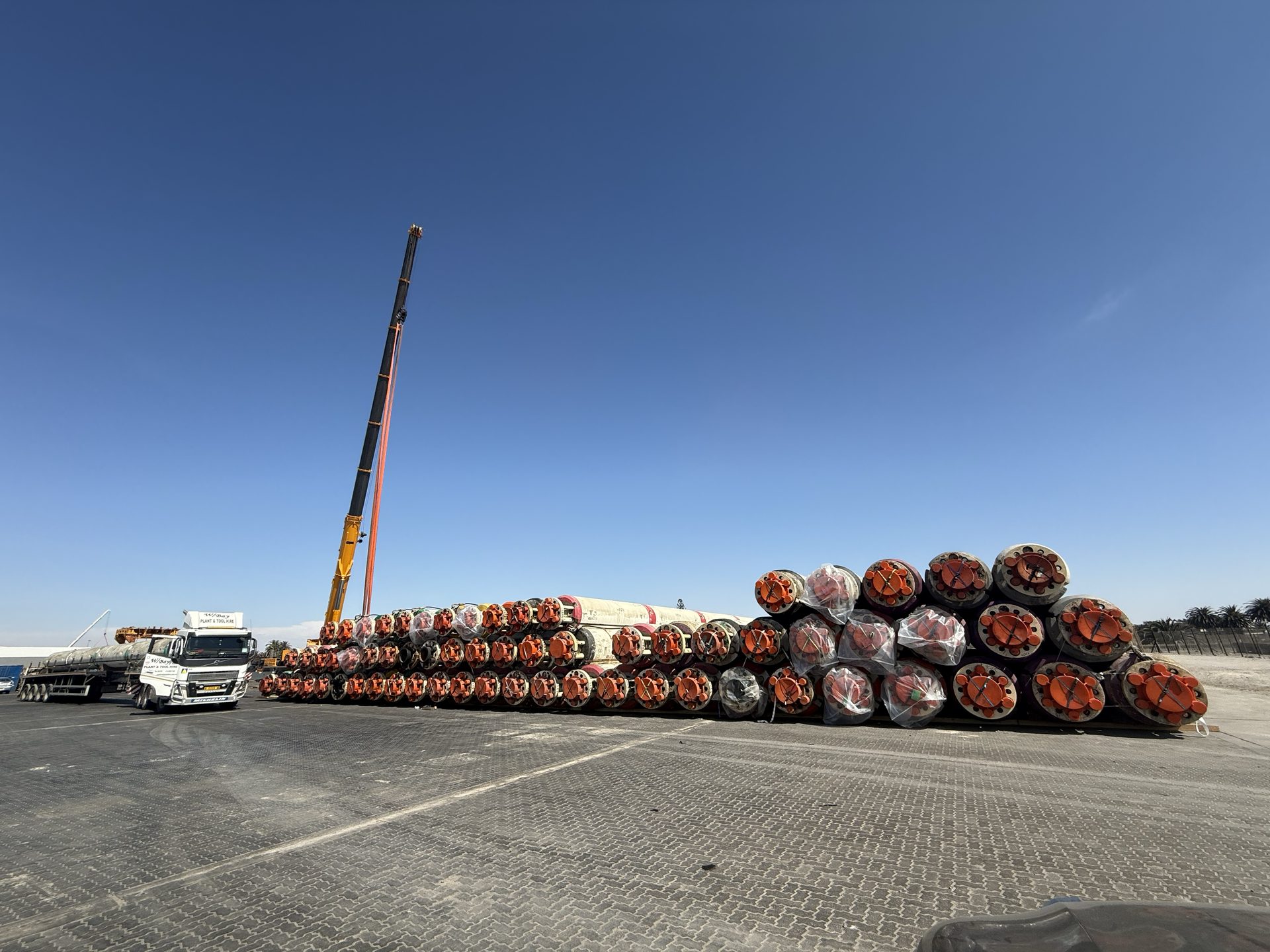 Riser joints laid down with a mobile crane on the port apron at the Port of Walvis Bay, Namibia – Afrishore offshore supply base and vessel & rig agency