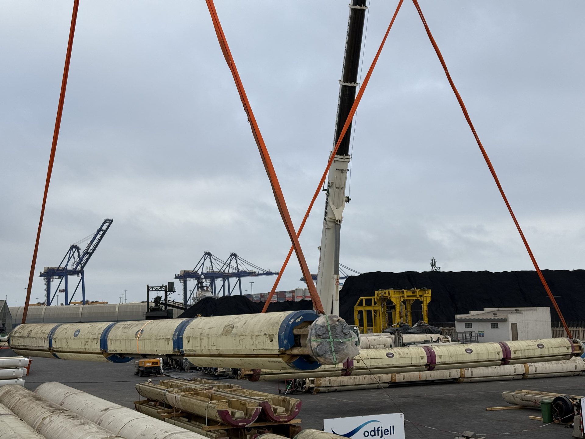 Subsea riser sections rigged with crane slings at Afrishore's offshore supply base laydown yard in the Port of Walvis Bay, Namibia