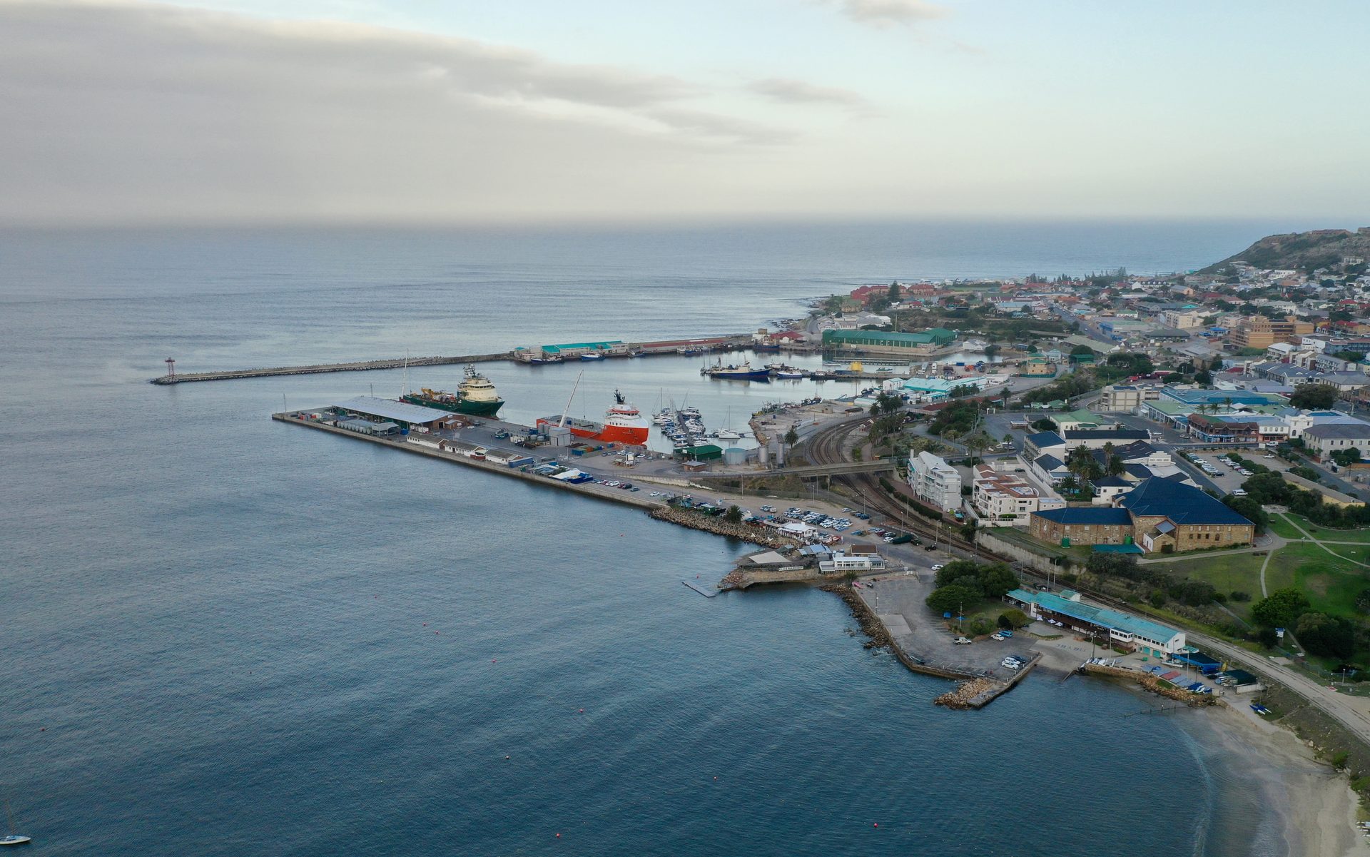 Aerial view of the Port of Mossel Bay, South Africa – offshore supply vessels alongside the breakwater quay where Afrishore provides vessel and rig agency services
