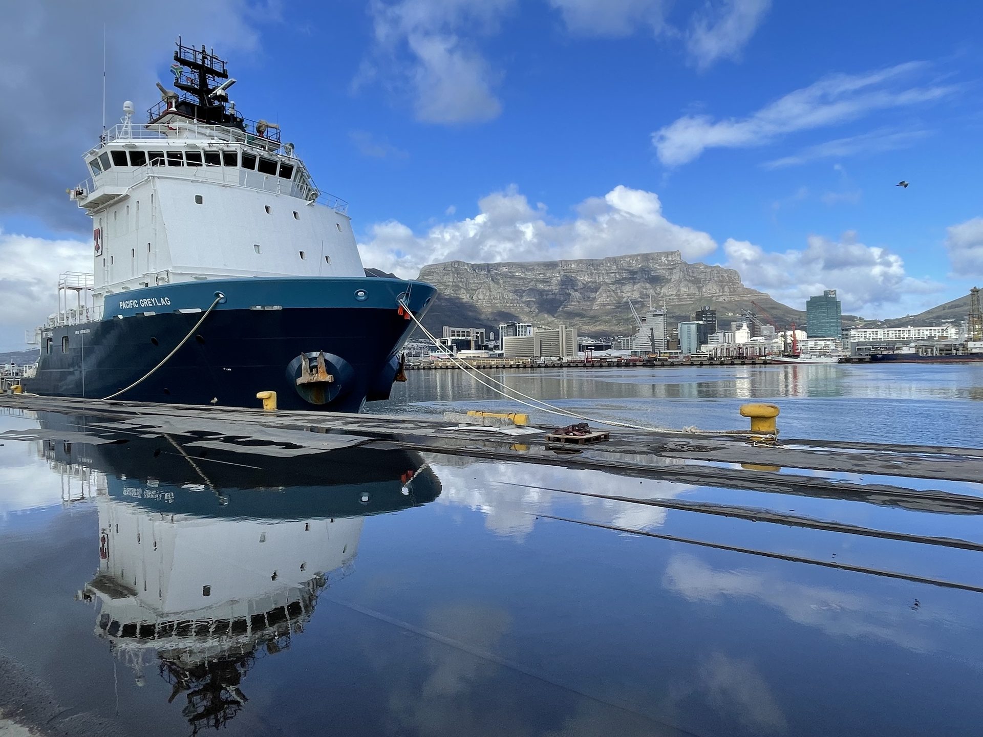 Pacific Greylag offshore supply vessel alongside in the Port of Cape Town with Table Mountain behind – Afrishore vessel and rig agency, South Africa